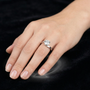 Round Moissanite Silver Solitaire Engagement Ring with a Swirl Band Design