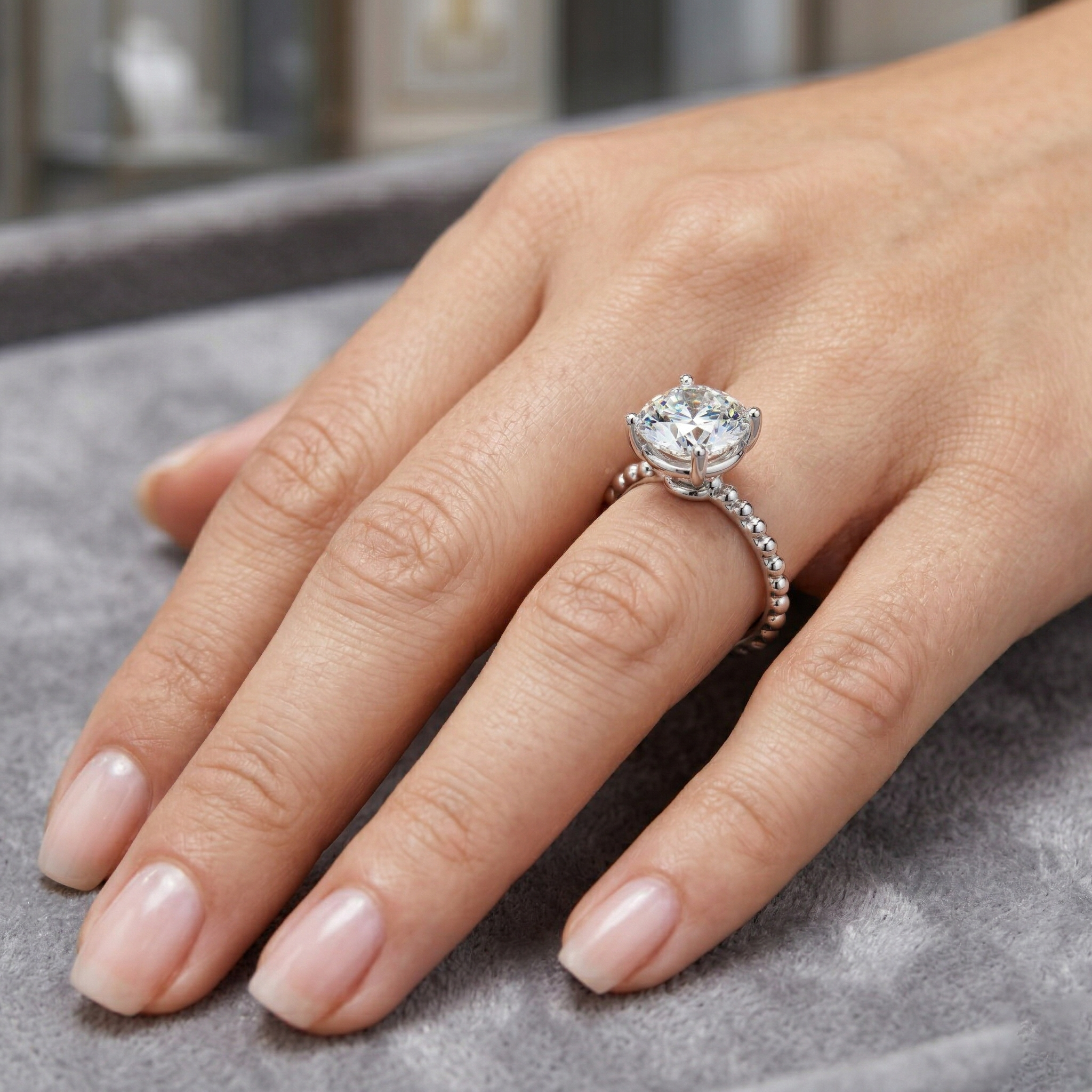Round Solitaire Moissanite Engagement Ring with a Beaded Milgrain Band in Silver