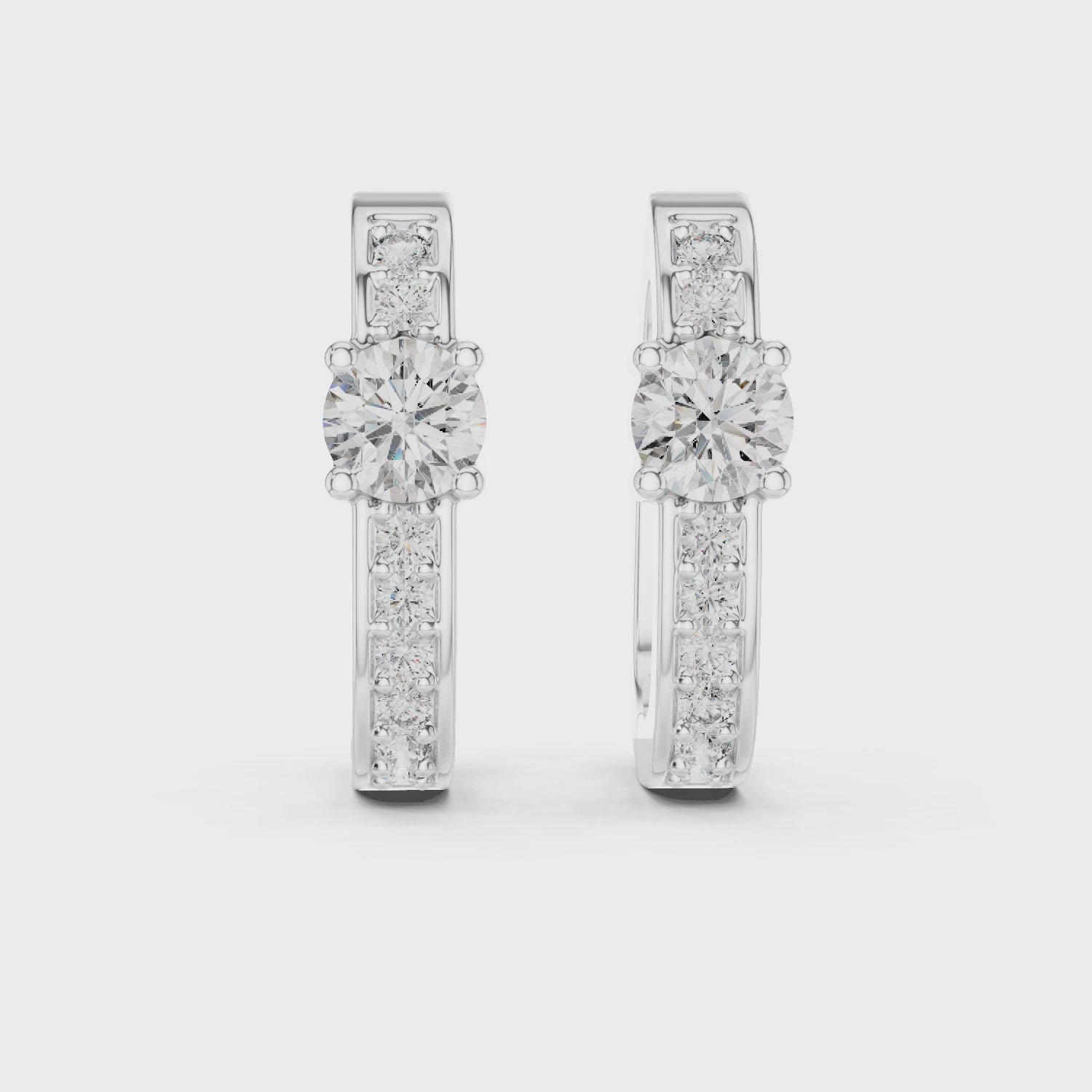 Prominent Center Round Diamond Surrounded By Smaller Pavé-Set Stones Hoop Earrings 