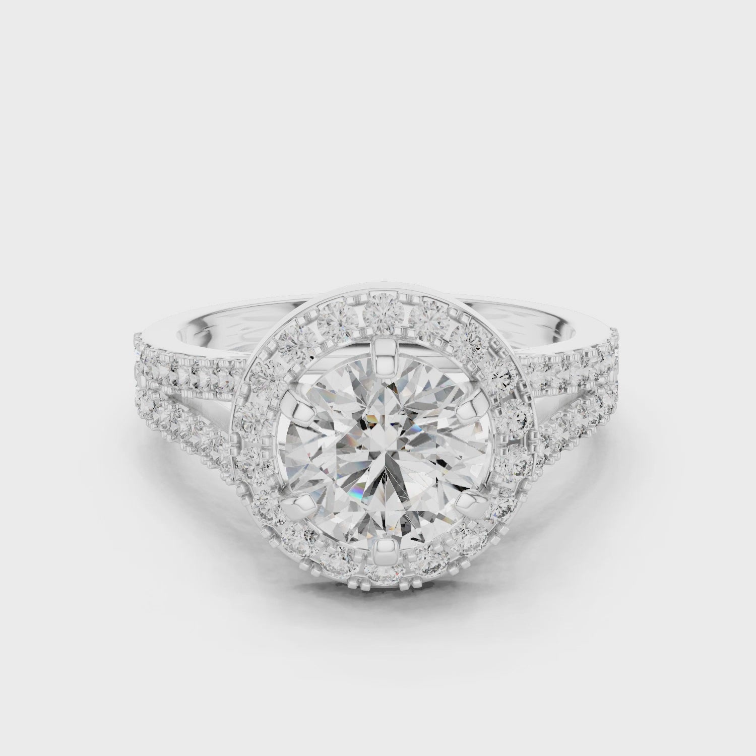 Brilliant Halo Engagement Ring With Central Round Cut Diamond Surrounded By Smaller Pavé Diamonds