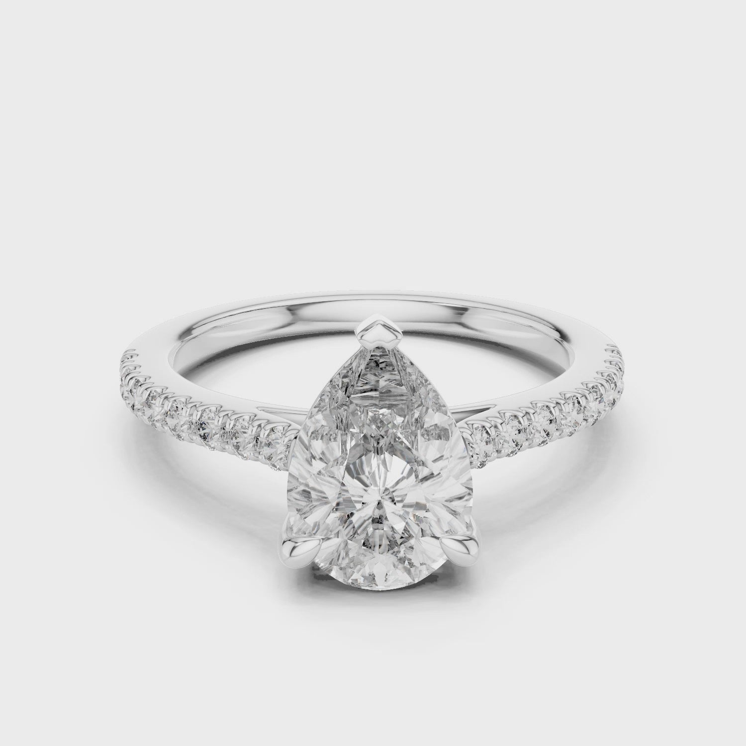 Pear-shaped Solitaire Moissanite Engagement Ring Featuring a Delicate Pave Band
